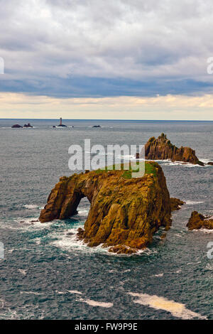 The Armed Knght and Enys Dodman sea stacks at Land's End with Longships lighthouse beyond, Cornwall, England, UK Stock Photo