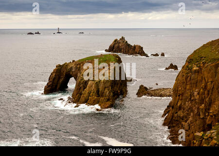 The Armed Knght and Enys Dodman sea stacks at Land's End with Longships lighthouse beyond, Cornwall, England, UK Stock Photo