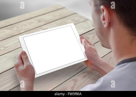 Tablet with isolated screen for mockup in man hands. Man sitting and holding tablet on table. Isolated device screen for design, Stock Photo