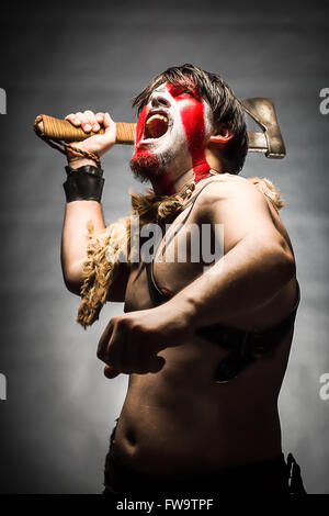 Portrait of screaming in rage ancient Spartan warrior in battle dress  against sky background Stock Photo - Alamy