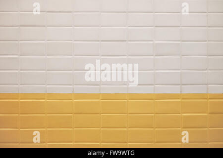 Subway wall background with white and yellow tiles texture Stock Photo
