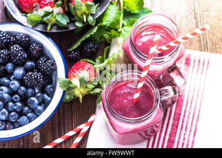 Preparation of antioxidant and refreshing smoothie, well being and weight loos concept. On wooden table from above. Stock Photo