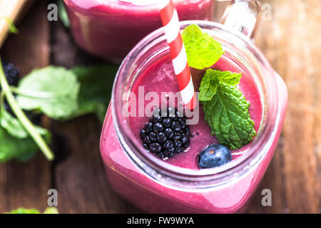 Well being and weight loss concept, berry smoothie.On wooden table with ingredients, from above. Stock Photo