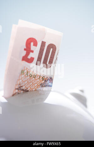 Ten pound British note in piggy bank,saving concept Stock Photo