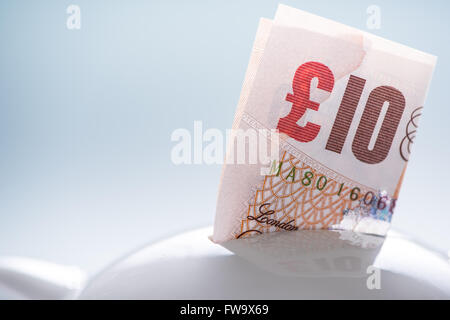 Ten pound British note in piggy bank,saving concept Stock Photo