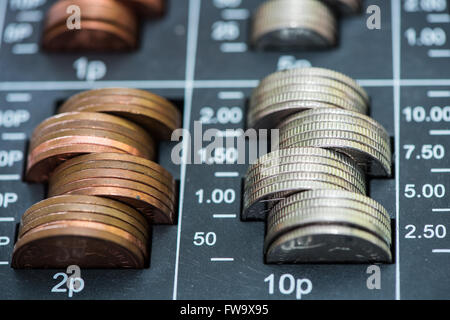 Pile of coins in cash register, british pounds sterlings Stock Photo