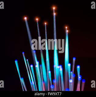 optical fibres dinamic flying from deep on technology background Stock Photo