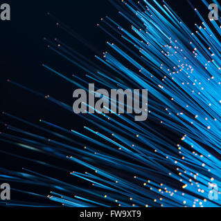 optical fibres dinamic flying from deep on technology background Stock Photo