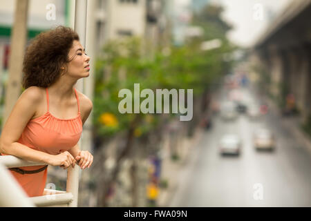 Beautiful Asian woman standing on the overpass. Stock Photo