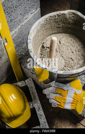Tools for bricklayer bucket with a solution and a trowel, close-up Stock Photo