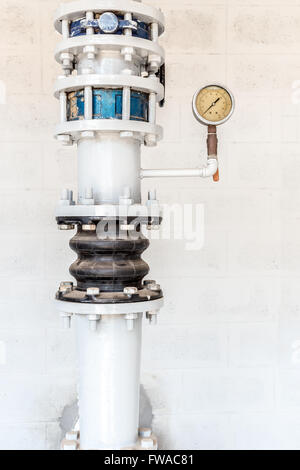 old pressure gauge and steel tube in pump room Stock Photo