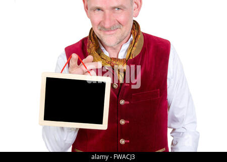 portrait of bavarian man wearing traditional bavarian clothes holding a small blackboard Stock Photo