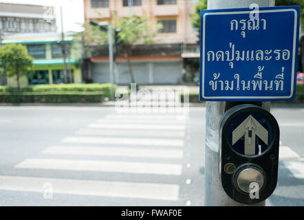 push button for Red traffic light in Thailand. thai language -- (Selective focus) Stock Photo