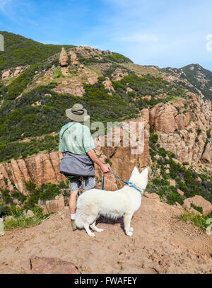 Hiker and dog on the MIshe Mokwa Trail at Circle X Ranch see Echo Cliffs, rock climbers and Balanced Rock Stock Photo