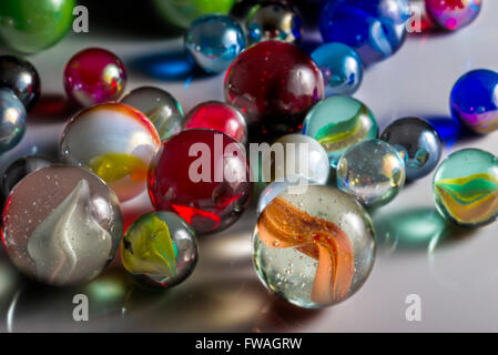 Closeup view of translucent marbles on a shiny surface Stock Photo