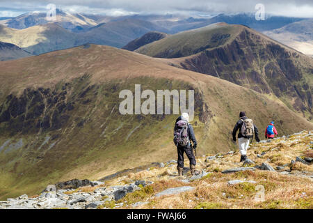 People hikers hiking descending Craig Cwm Silyn towards Mynydd Tal-y-mignedd on Nantlle Ridge in mountains of Snowdonia National Park (Eryri) Wales UK Stock Photo