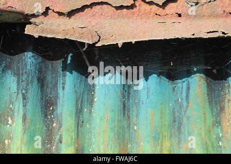 An old tin shack with brightly painted corrugated sheet metal and rusting roof Stock Photo