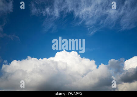Cumulonimbus and Cirrus cloud formations against a bright blue sky. UK. Stock Photo