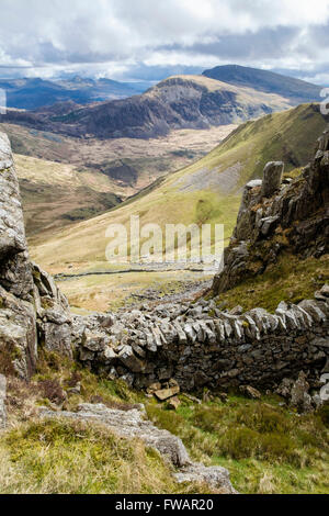 View SE to distant Moel Hebog mountain across Cwm Pennant from Craig Cwm Silyn on the Nantlle Ridge in Snowdonia National Park. Wales UK Britain Stock Photo