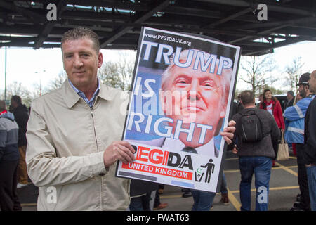 Birmingham UK. 2nd April 2016. A Pegida supporter holds a placard of US presidential candidate Donald Trump. Former (EDL) English Defence League leader Tommy Robinson leads a Pegida march with his supporters  in Birmingham against the growing Islamisation of Britain and European countries Credit:  amer ghazzal/Alamy Live News Stock Photo