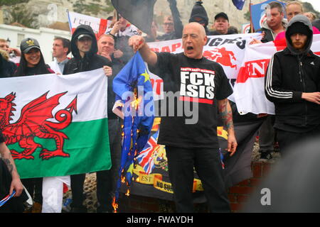 Dover, Kent, UK. 2nd April, 2016. Far right protester burns the European flag. Anti-Fascist groups, including London Anti-Fascists, Kent Anti-Racism Network (KARN) and Unite Against Fascism (UAF), take to the streets of Dover to counter demonstrate a far right Unity march through the town center led by the right wing group South East Alliance,  which includes the National Front (NF) and English Defence League (EDL). Penelope Barritt/Alamy Live News Stock Photo