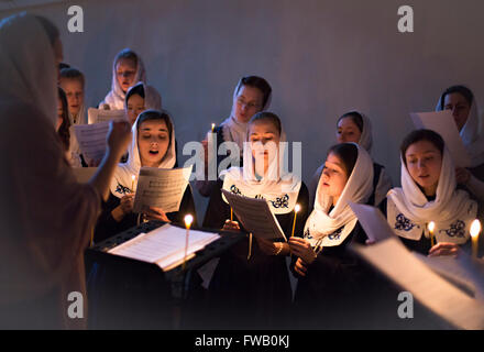 A Russian Orthodox women sing hymns during Veneration of the Cross Great Vespers service at the Theological Academy April 2, 2016 in Saint Petersburg, Russia. The veneration is held on the Third Sunday of Great Lent in accordance with Orthodox beliefs. Stock Photo