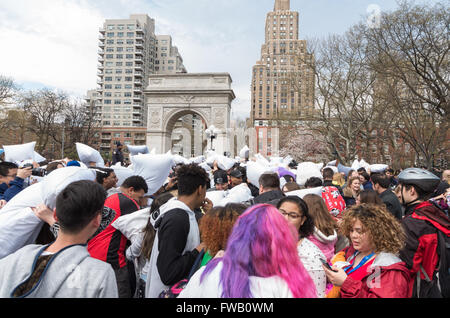 Crowds of young people taking part in the world's largest pillow fight flash mob in Washington Square Park, New York. Stock Photo