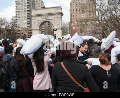 Crowds of young people taking part in the world's largest pillow fight flash mob in Washington Square Park, New York. Stock Photo