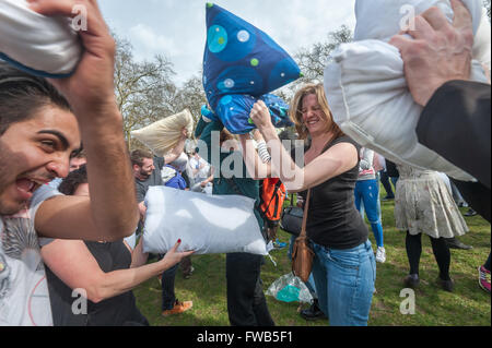 London, UK. 2nd April, 2016. Hundreds come armed with pillows to take part in a giant pillow fight despite official attempts to stop this annual event, moved at 24 hours notice to Kennington Park. A few left when police told them the event was cancelled, but most stayed to enjoy the fight.  This was the 9th year of similar massive pillow fights in over 50 other cities around the world inspired by the urban playground movement, claiming cities are public spaces for people. Peter Marshall/Alamy Live News Stock Photo