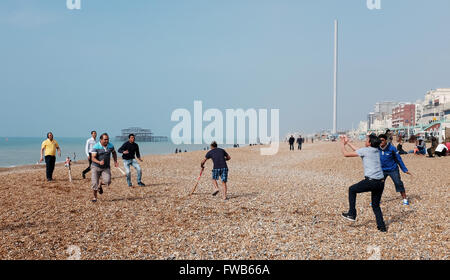 Brighton, UK. 3rd April, 2016. On the same day as the T20 Cricket World Cup Final is held  in India a group enjoy an impromptu game on Brighton beach this morning in the warm sunny weather with temperatures in some parts of Britain forecast to reach the high teens centigrade later on  Credit:  Simon Dack/Alamy Live News Stock Photo
