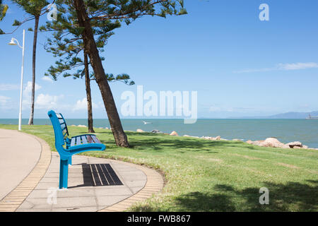 Blue park bench on The Strand beach, Townsville, Australia with sea view Stock Photo