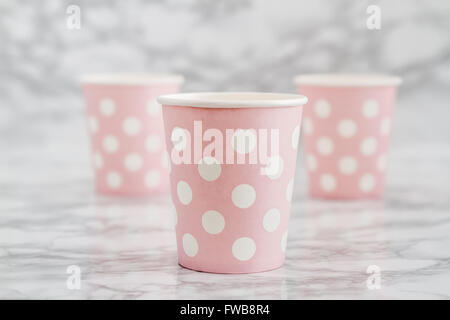 Group of pink  disposable paper cups on white marble background Stock Photo