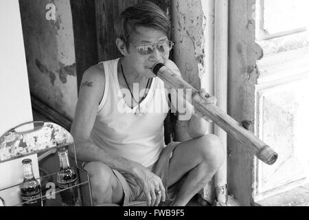 Man smokes a bamboo pipe, Hanoi, Vietnam Stock Photo