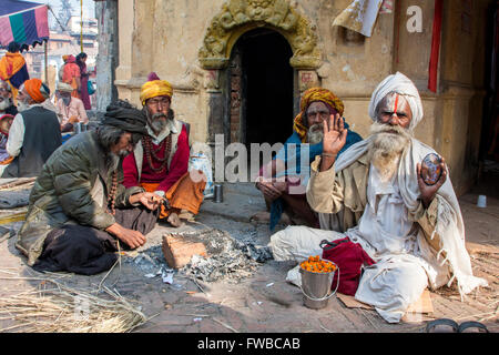 Nepal, Pashupatinath.  Hindu Sadhus (Ascetics) Enjoying One Another's Company. Stock Photo