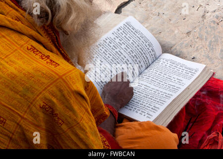 Nepal, Pashupatinath.  Hindu Sadhu (Ascetic) Reading Hindu Scriptures. Stock Photo