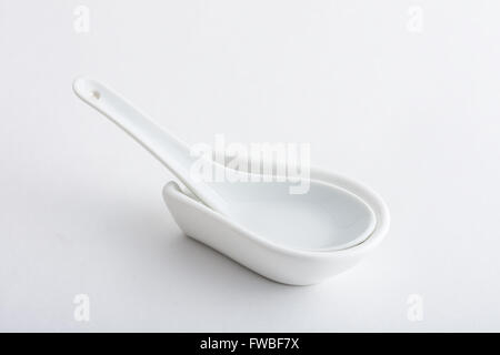 Empty ceramic bowl with spoon Stock Photo