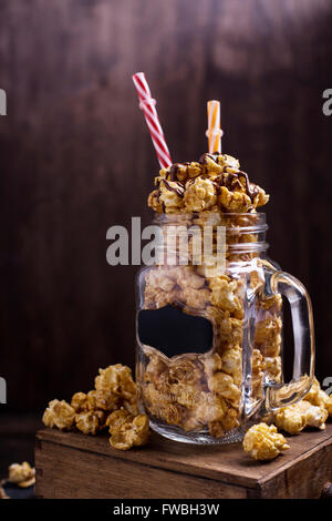 Sweet caramel popcorn in a glass jar