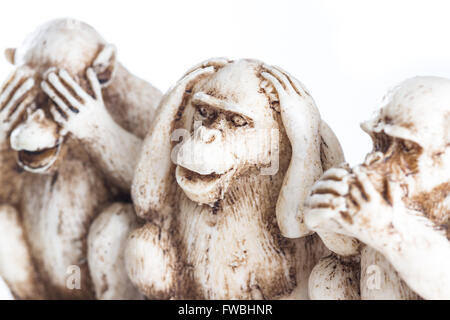 close up of hand small statues with the concept of see no evil, hear no evil and speak no evil. Stock Photo