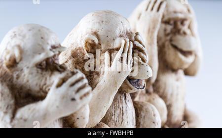 close up of hand small statues with the concept of see no evil, hear no evil and speak no evil. Stock Photo