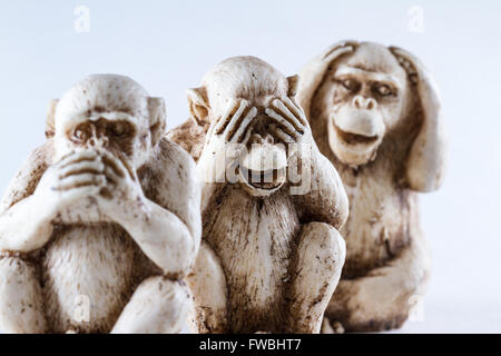 close up of hand small statues with the concept of see no evil, hear no evil and speak no evil. Stock Photo