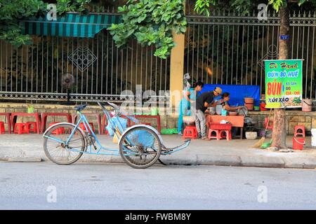 Rickshaw in front of local street restaurant, Hue, Vietnam, Asia Stock Photo