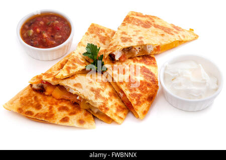 Five pieces Mexican quesadillas with cheese, two sauces and salsa isolated on white Stock Photo