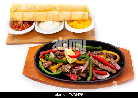 traditional mexican beef fajitas on isolated white background Stock Photo