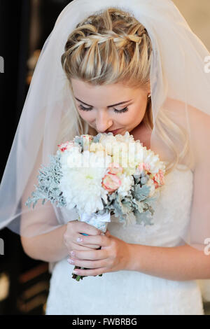 Bride holding white wedding bouquet of roses Stock Photo