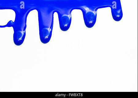 close up of blue paint leaking on white background Stock Photo