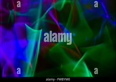 Abstract light trails form a pattern created from glowing chemical sticks or night lights. Stock Photo