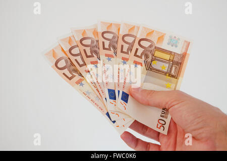 Man's hand holding euro bank notes. Close view. Stock Photo
