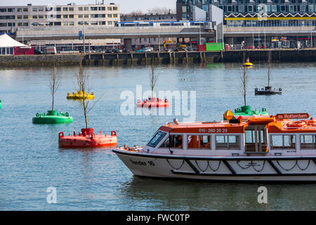 Art Action Dobberend Bos, of artists from Rotterdam, a forest of floating elm trees, in disused North Sea buoys in a harbor, Stock Photo