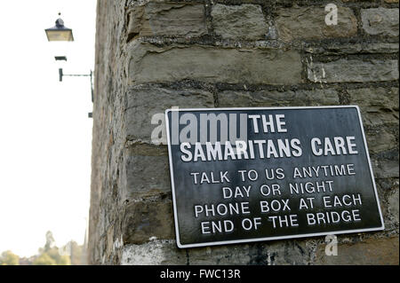 A sign on the entrance to the Clifton Suspension bridge in Bristol, UK advertising the servcies of the Samaritans who help people who may be at the end of their tether adn are contemplating suicide by jumping from the bridge in to the avon below. Stock Photo