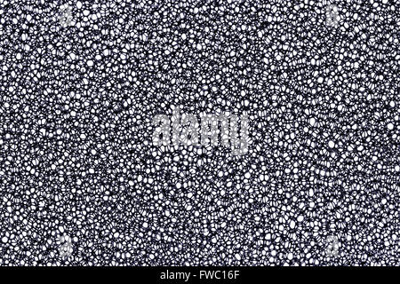 Macro photo of a black open-cell reticulated polyurethane foam structure, creating an abstract porous cellular pattern Stock Photo